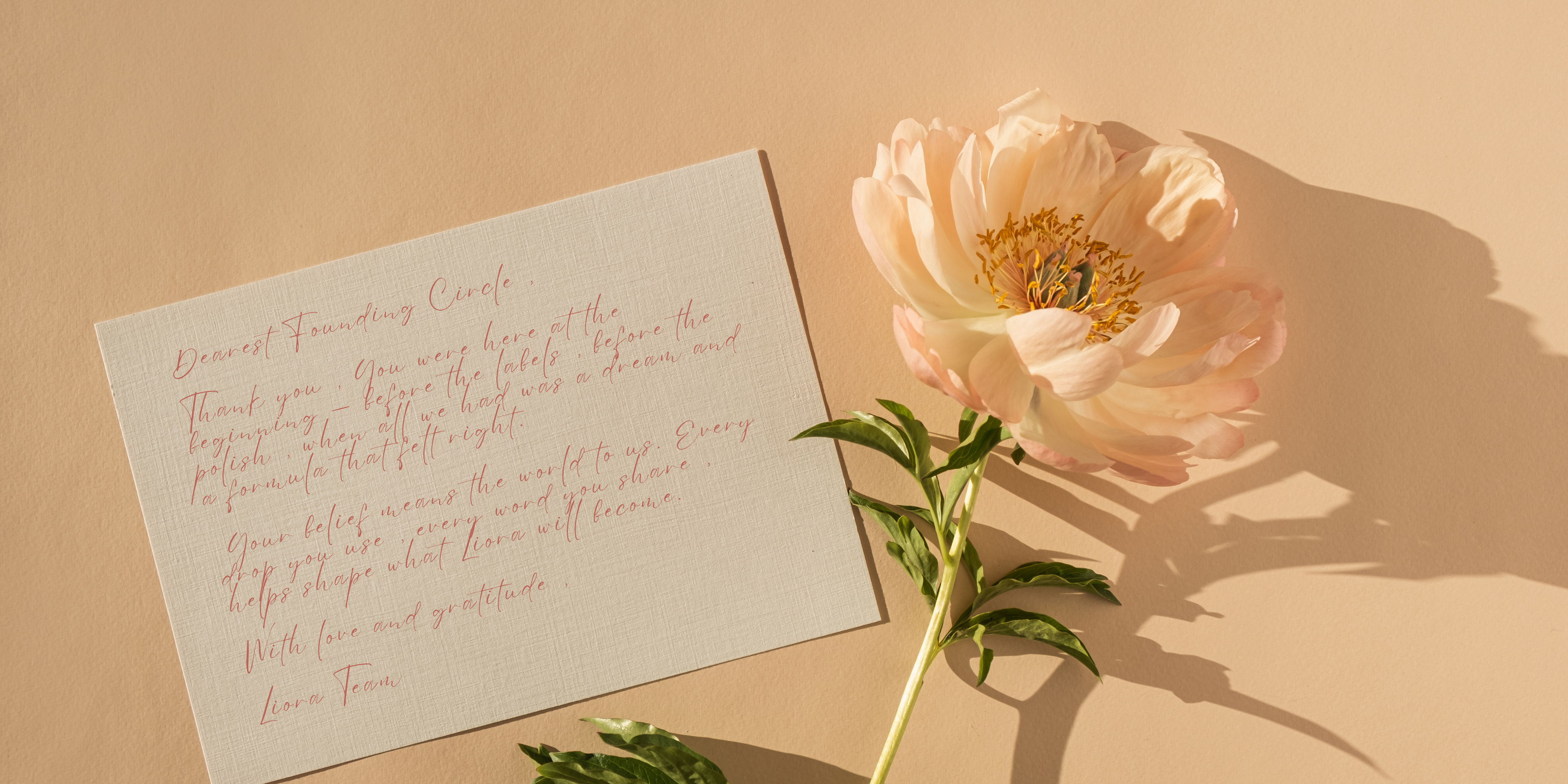 Floral arrangement with a letter on a beige background
